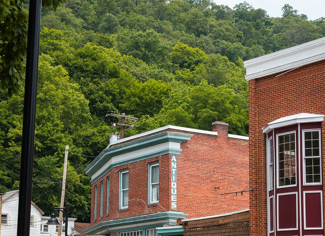 Beckley WV Insurance - Picture of Antique Building in West Virigina with Green Trees in the Background